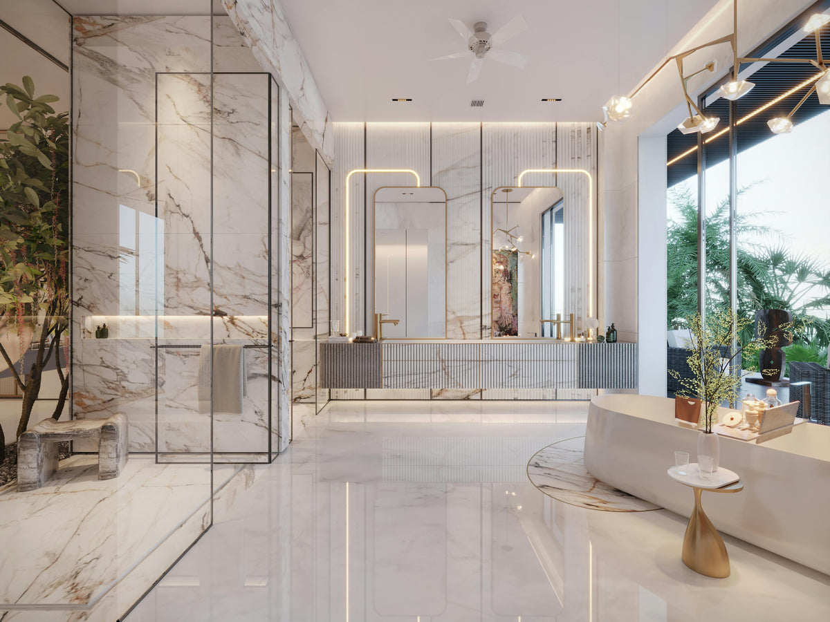 Light-filled bathroom with marble surfaces, a freestanding bath and warm metallic finishes.